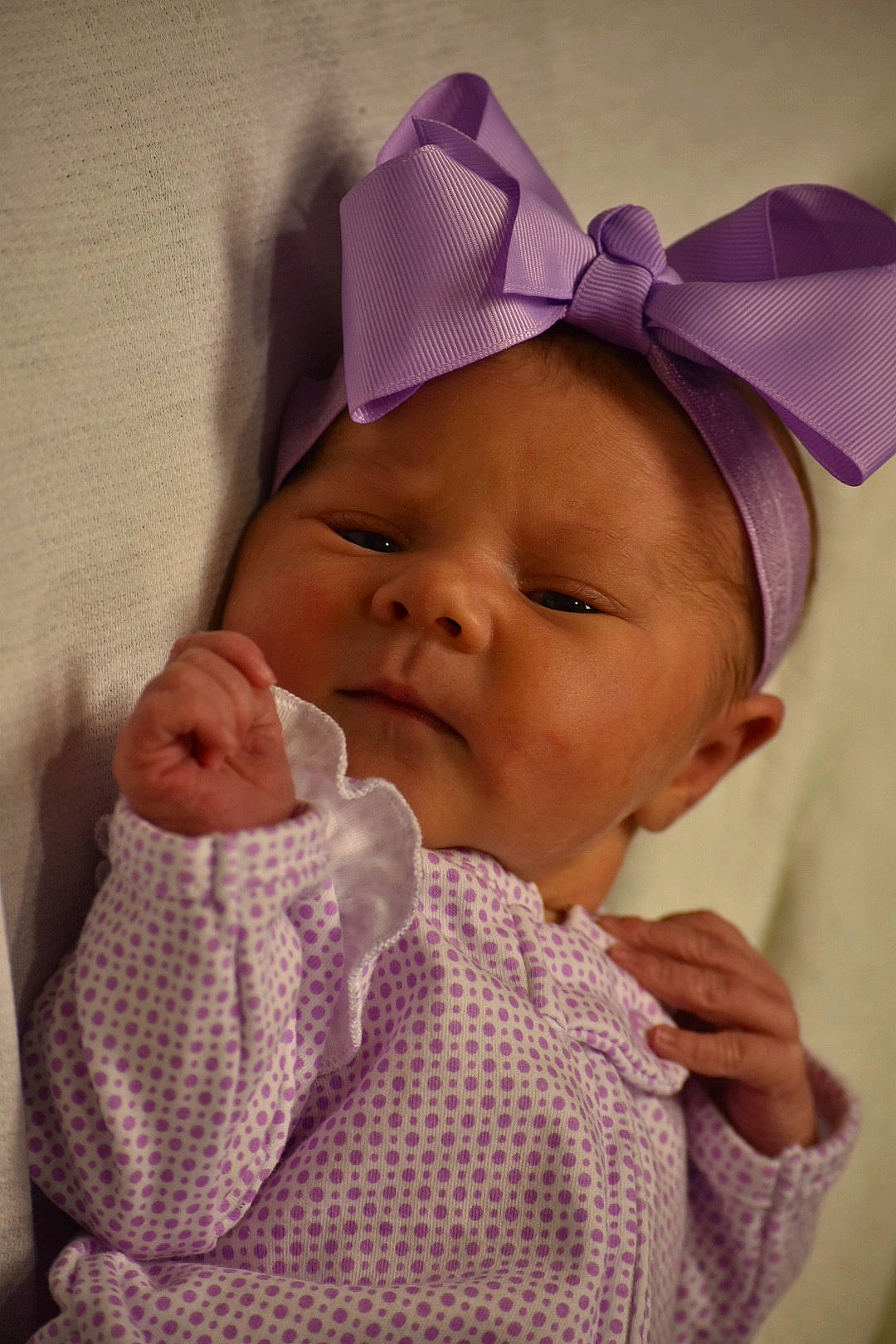 Whitley is registered to the contest to win money with this photo: baby, cheek, child, eye, face, fashion_accessory, forehead, hand, head, headgear, lip, mouth, nose, person, pink, product, purple, room, skin, textile