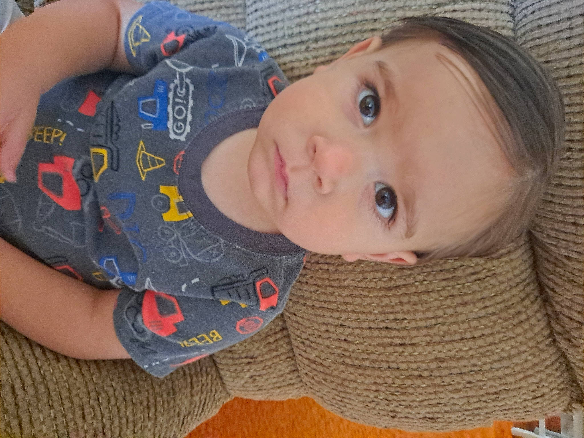 Knox is registered to the contest to win money with this photo: cheek, child, cool, elbow, eyelash, face, fun, human_body, lip, mouth, neck, nose, pattern, person, skin, sleeve, textile, toddler, wood, wool