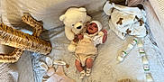 Messon participe au concours pour gagner de l'argent avec cette photo : baby, soft_blanket, stuffed_toy, bottle, baby_clothes, plush_toy, baby_hat, baby_socks, wooden_beads, woven_basket, cushion, floor_rug, baby_toy, fabric, infant, lying_down, indoor, cute, child, nursery