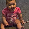 baby, infant, child, pink_clothing, sitting, carpet, indoor, cute, smiling, young, person, human, chubby_cheeks, short_hair, barefoot, hand, foot, portrait, childhood, casual