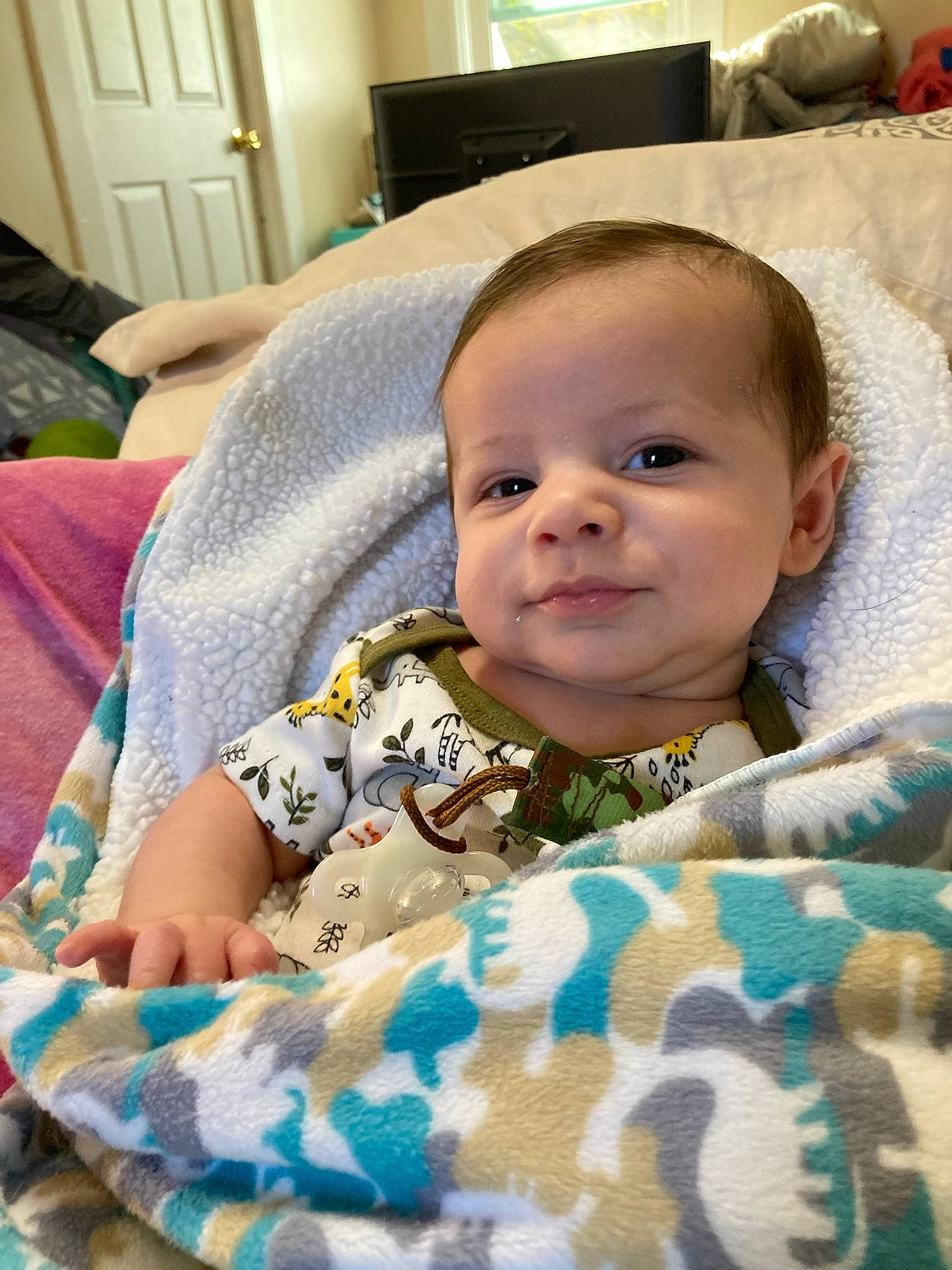 Kenzo is registered to the contest to win money with this photo: baby, baby_toddler_clothing, cheek, child, chin, comfort, eye, eyebrow, face, facial_expression, hairstyle, happy, head, iris, linens, nose, person, skin, sleeve, smile