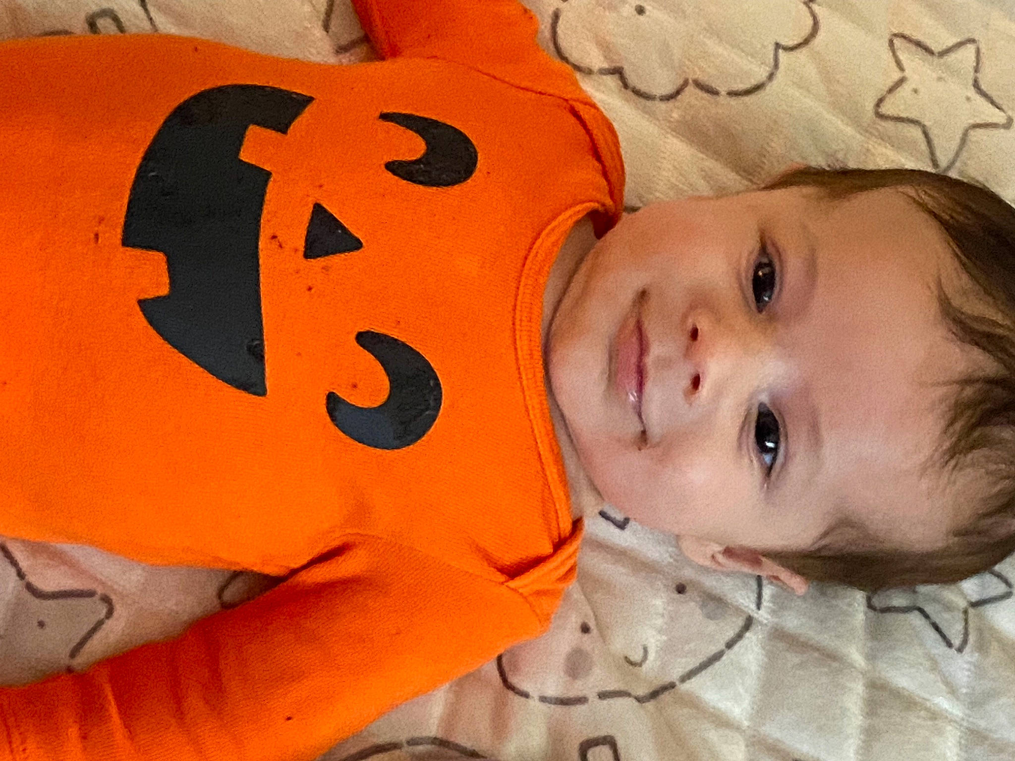 Kenzo is registered to the contest to win money with this photo: baby, baby_toddler_clothing, calabaza, cheek, child, chin, eye, face, fun, happy, head, joy, mouth, nose, orange, person, plant, skin, smile, textile