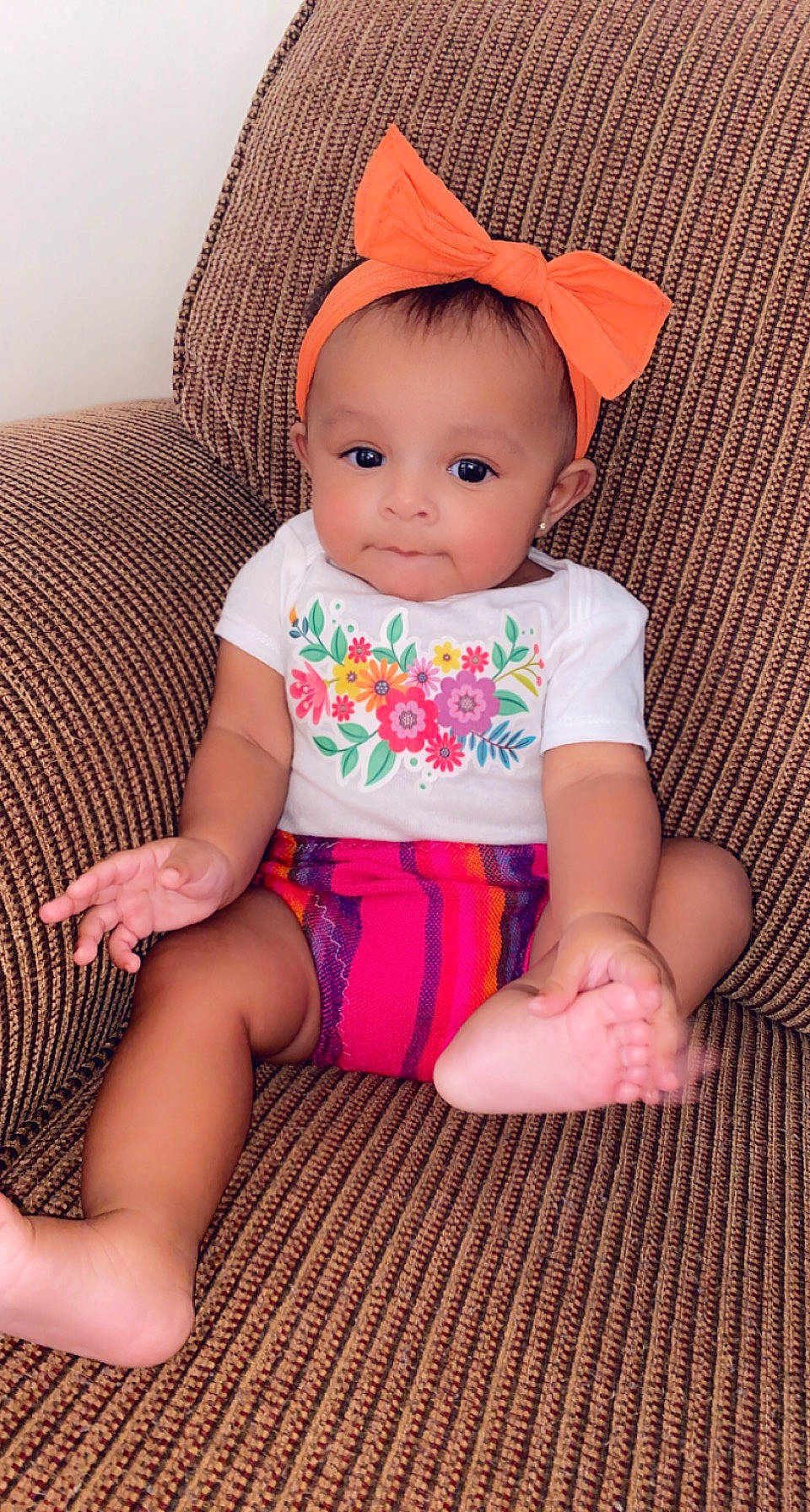 Miamor is registered to the contest to win money with this photo: baby, baby_toddler_clothing, cap, cheek, child, comfort, fashion_accessory, finger, foot, human_leg, lap, pattern, person, pink, sitting, skin, sleeve, sock, thigh, toddler