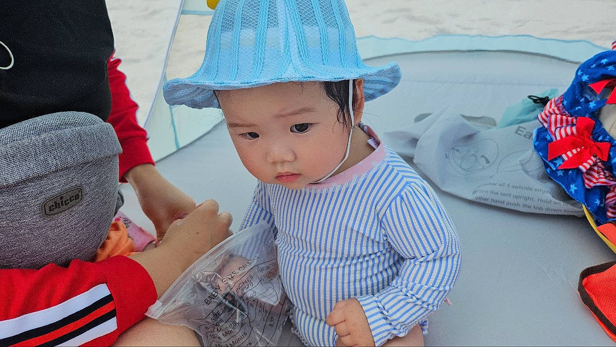 Isla joined the competition — help win amazing prizes! baby, baby_toddler_clothing, baseball_cap, cap, child, event, fashion_accessory, fun, grass, happy, hat, headwear, leisure, pattern, person, recreation, sitting, sleeve, sun_hat, toddler