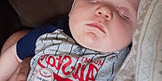 Kenneth joined the competition — help win amazing prizes! baby, baseball, blanket, child, closeup, clothing, comfort, cute, face, hand, indoor, infant, onesie, peaceful, portrait, relaxing, resting, sleeping, soft, toddler
