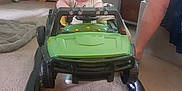 Kenneth joined the competition — help win amazing prizes! baby, child, toy_car, walker, indoor, car, floor, carpet, furniture, plant, adult, leg, green, white, person, home, room, lighting, seat, toy