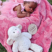 Ahlora joined the competition — help win amazing prizes! baby, pink, blanket, stuffed_animal, outdoor, grass, headband, toddler, toy, cute, portrait, child, young, soft_texture, resting, infant, plush, sleepy, newborn, peaceful