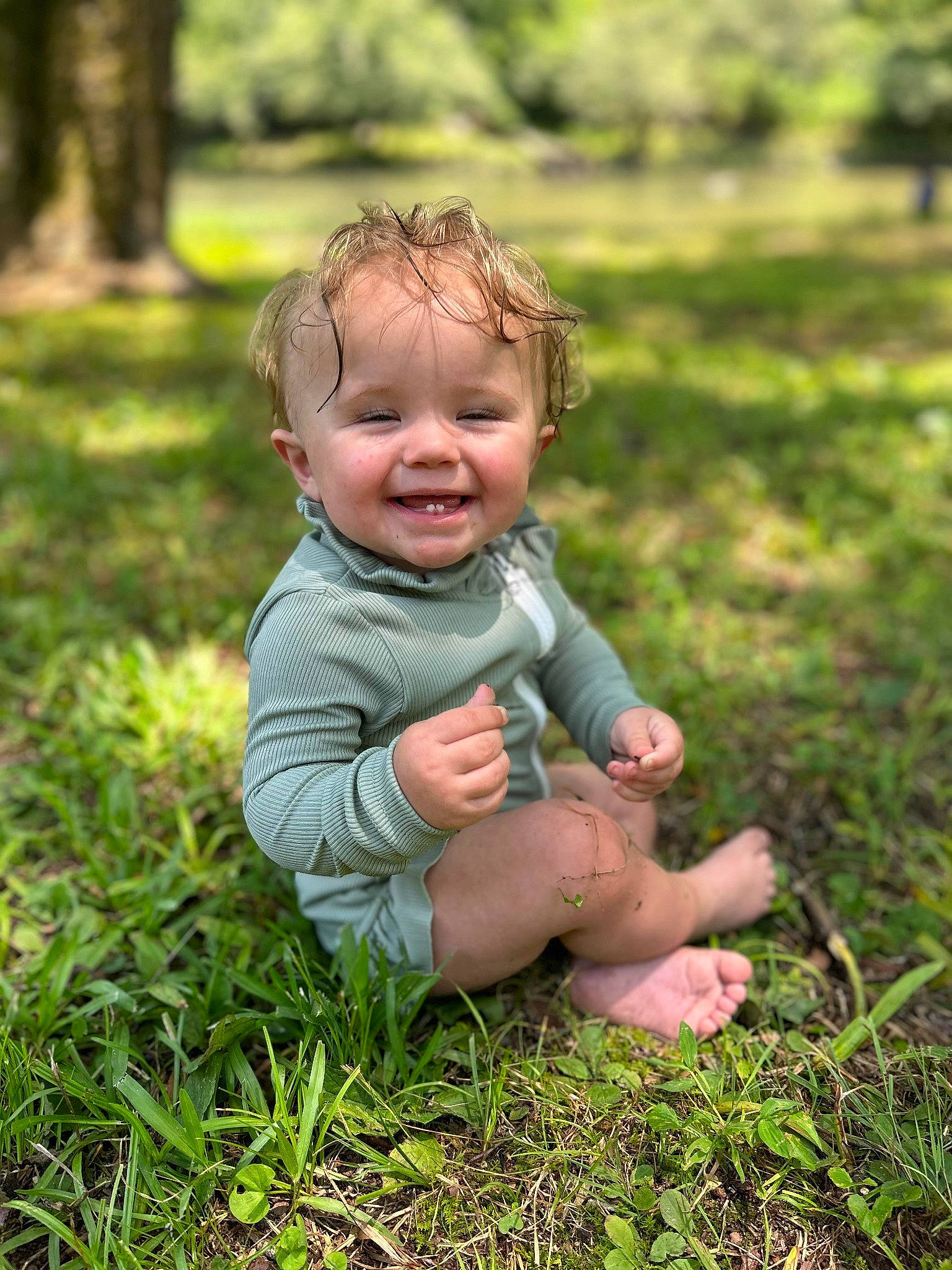 Hadley is registered to the contest to win money with this photo: baby, botany, face, gesture, grass, grass_family, grassland, happy, head, joy, leaf, mammal, meadow, nature, people_in_nature, person, plant, smile, sunlight, toddler