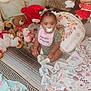 Dior joined the competition — help win amazing prizes! baby, child, pacifier, bib, stuffed_animals, teddy_bear, blanket, cushion, sitting, floor, indoor, cute, infant, plush_toys, patterned_rug, decorative_pillow, soft_toys, green_clothing, white_socks, portrait
