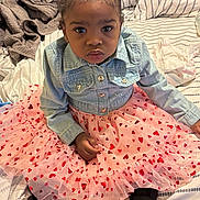 Aarionna joined the competition — help win amazing prizes! child, toddler, baby, portrait, sitting, bedroom, bed, denim_jacket, pink_dress, tutu, heart_pattern, hair_bow, red_bow, black_shoes, fashion, cute, serious_expression, indoors, bedding, photography