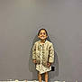 casual, child, clothing, cute, dress, fashion, feet, floor, girl, happy, indoor, jacket, person, portrait, shoes, smiling, sneakers, standing, wall, young