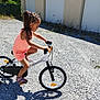 Rose participe au concours pour gagner de l'argent avec cette photo : child, girl, bicycle, bike, outdoor, gravel, sunlight, shadow, garage, building, hair, braids, pink_beads, sandal, summer, play, exercise, active, young, casual_clothing