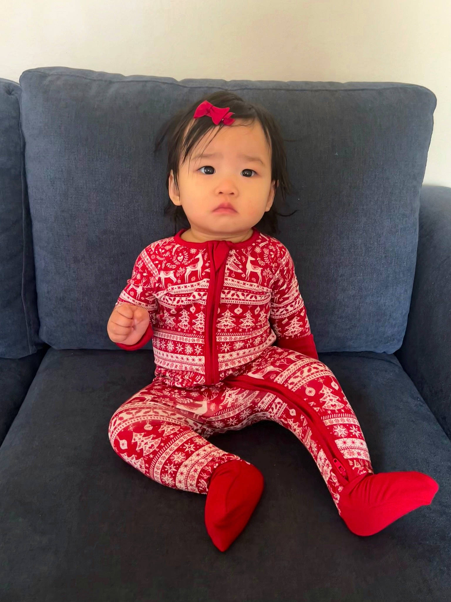 Malia is registered to the contest to win money with this photo: arm, baby, baby_toddler_clothing, carmine, cheek, child, collar, comfort, couch, embellishment, human_body, human_leg, lip, magenta, neck, pattern, person, sitting, sleeve, thigh