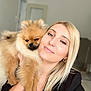 Tao a rejoint le concours — aidez-le/la à gagner de superbes lots ! black_clothing, blonde_hair, closeup, cute, dog, earrings, face, friendly, fur, happy, holding, home, indoor, jewelry, pet, pomeranian, portrait, selfie, smile, woman