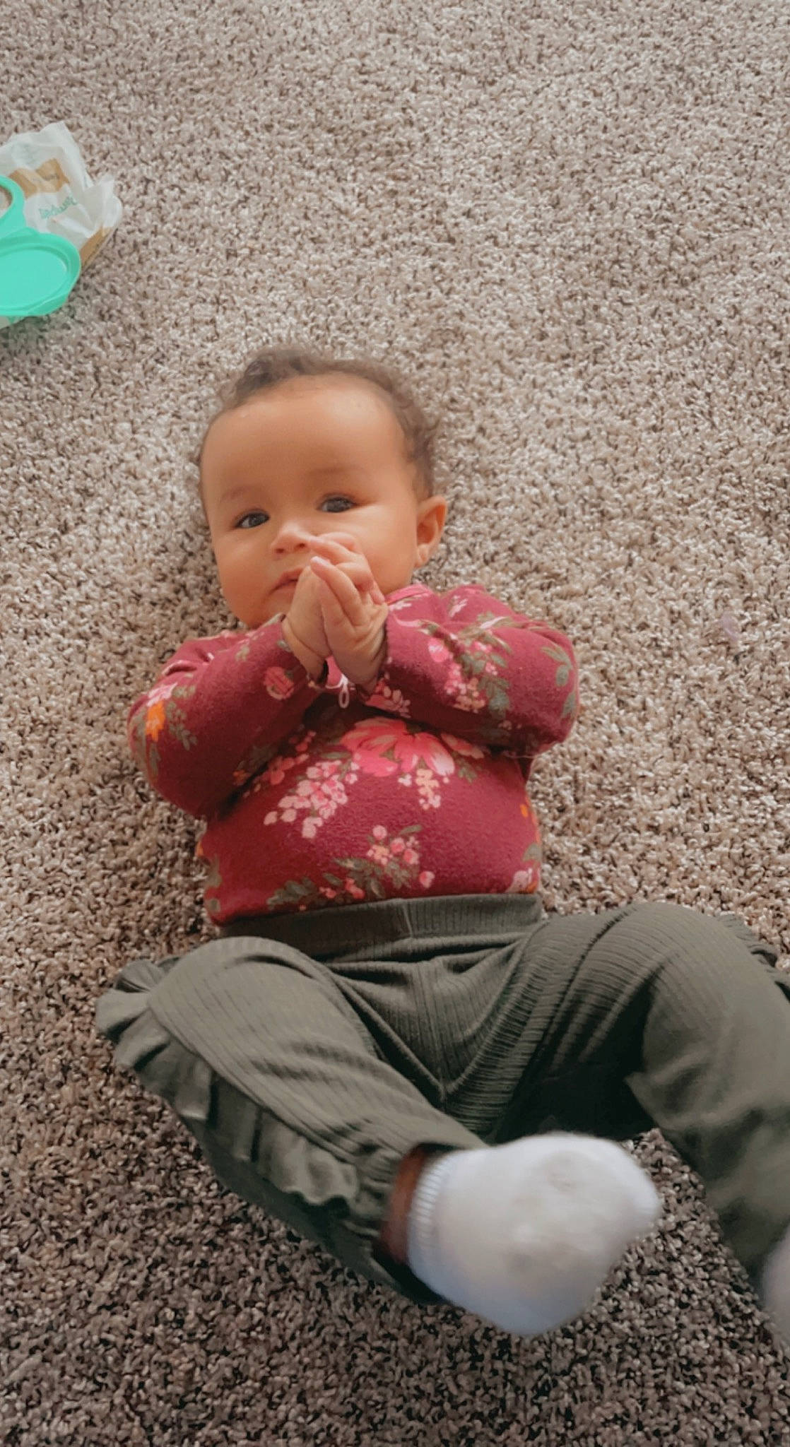 Gigi is registered to the contest to win money with this photo: baby, baby_toddler_clothing, cheek, child, comfort, eye, facial_expression, flooring, fun, grass, happy, head, human_body, leg, people_in_nature, person, sitting, skin, standing, toddler
