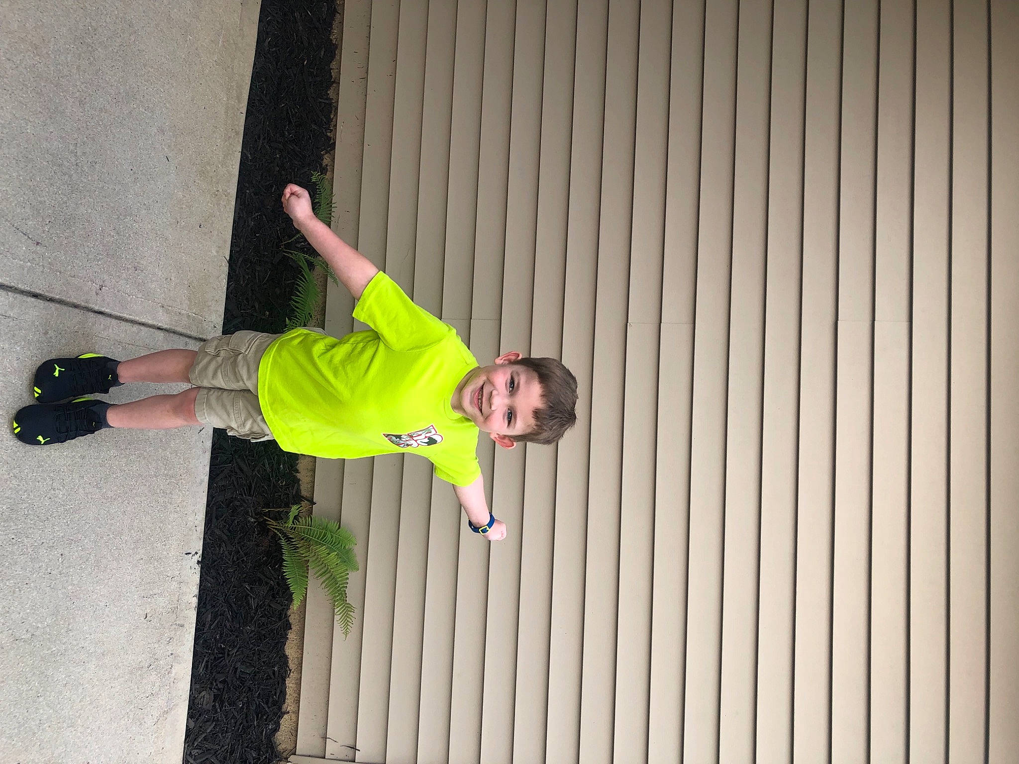 Austin is registered to the contest to win money with this photo: balance, fun, grass, happy, joy, person, recreation, sleeve, street_fashion, symmetry, t_shirt, walking_shoe, wood, wrist