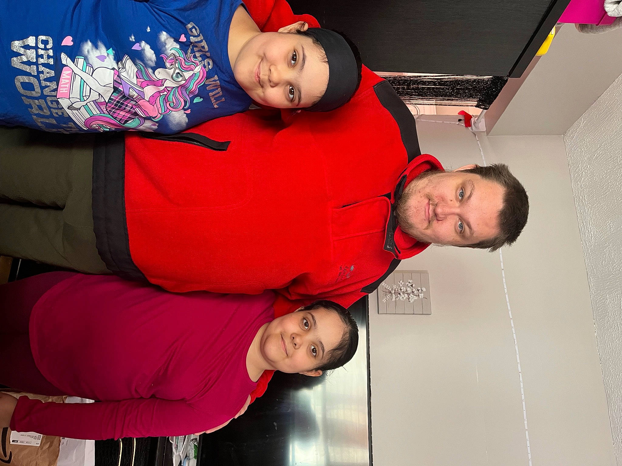 Maria is registered to the contest to win money with this photo: baby, baseball_cap, beard, cap, child, comfort, elbow, event, fun, gesture, happy, headwear, joy, leisure, magenta, mouth, person, red, room, sleeve