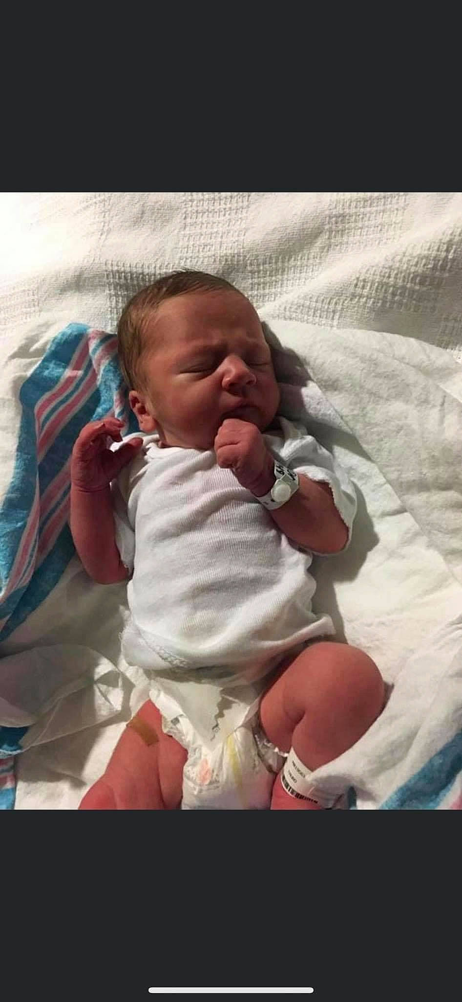 Remington is registered to the contest to win money with this photo: baby, baby_safety, baby_sleeping, baby_toddler_clothing, bedding, cheek, comfort, face, finger, fun, gesture, happy, linens, lip, mouth, nose, person, skin, textile, thumb