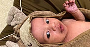 Kyrie is registered to the contest to win money with this photo: baby, blanket, bodypart, bonnet, clothing, face, finger, hand, happy, hat, head, hood, knitwear, person, photography, portrait, smile, sweater, toe, towel