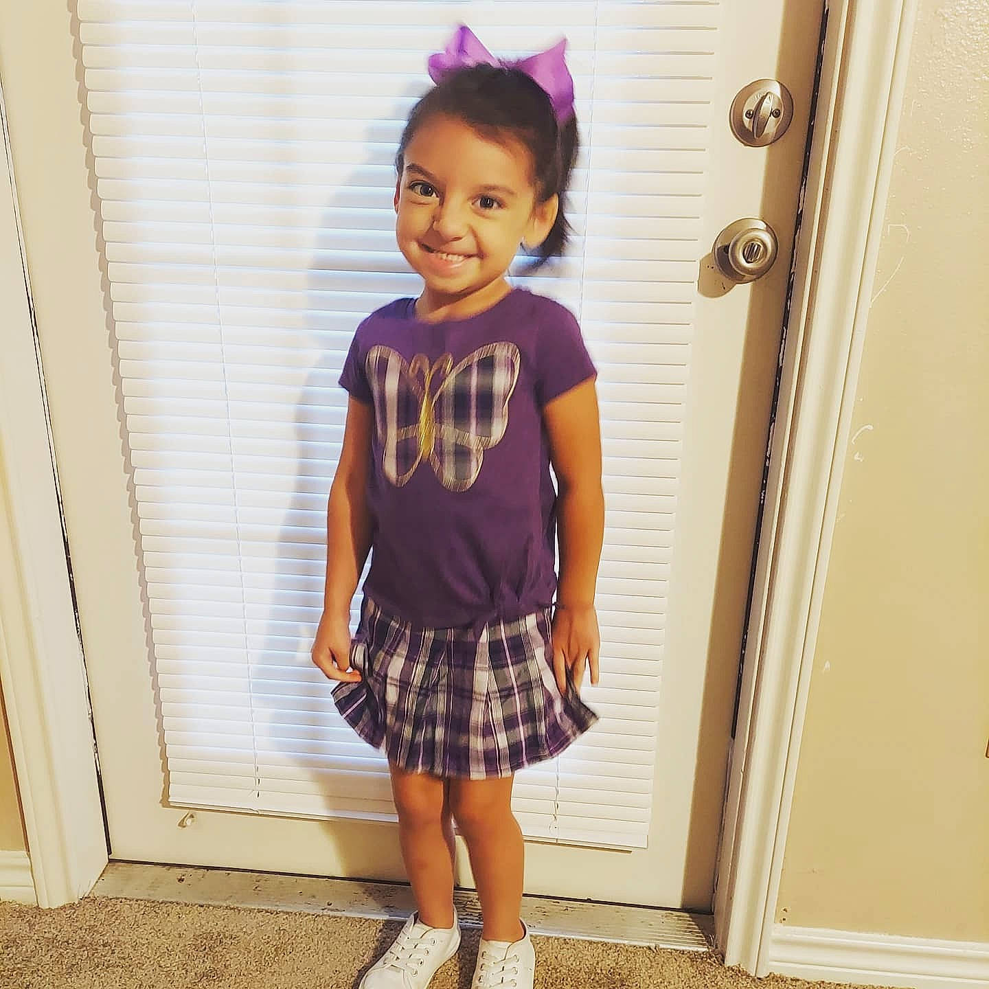 Macelyn joined the competition — help win amazing prizes! baby_toddler_clothing, clothing, day_dress, face, hair, hairstyle, happy, joy, knee, neck, person, pink, purple, shoulder, sleeve, smile, street_fashion, tartan, toddler, trunk