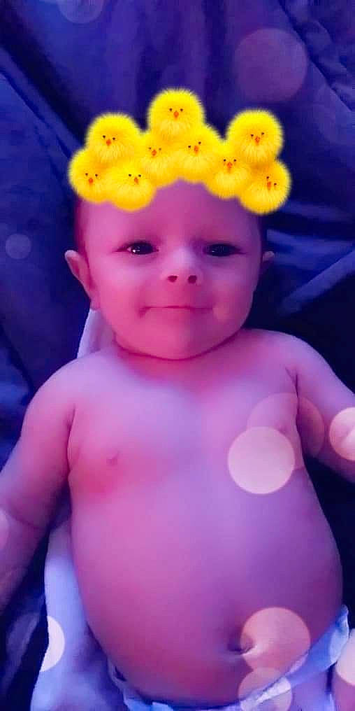 Keith is registered to the contest to win money with this photo: baby, baby_toddler_clothing, cheek, child, chin, eye, facial_expression, finger, happy, head, headwear, lip, magenta, neck, nose, person, petal, pink, product, skin