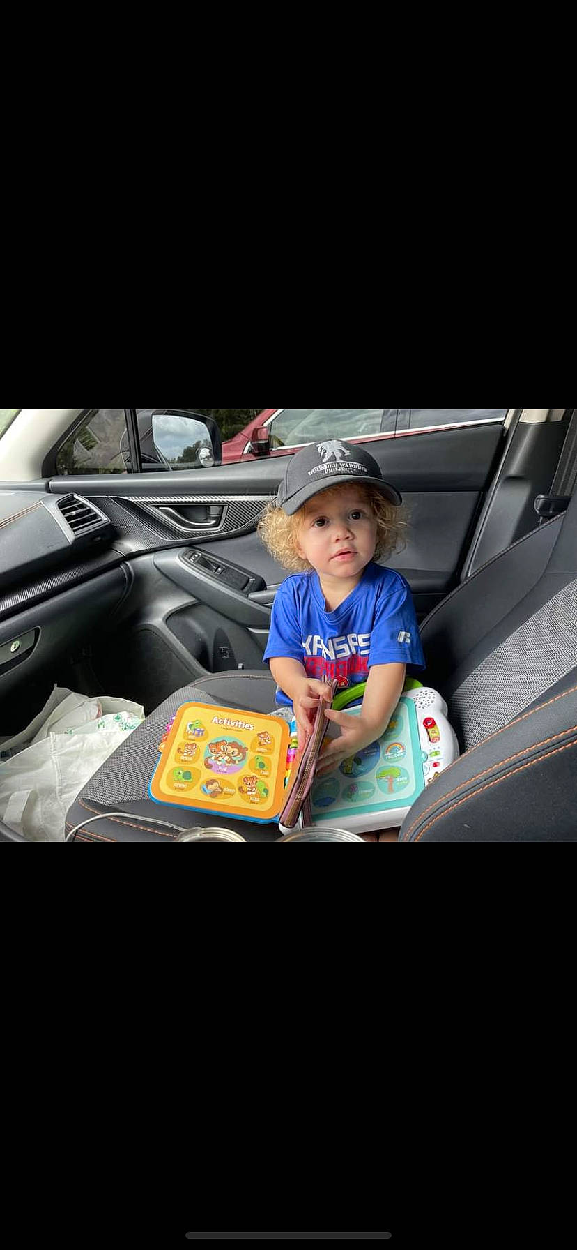 Aaydin is registered to the contest to win money with this photo: auto_part, automotive_design, automotive_exterior, baseball_cap, bumper, cap, car, family_car, hat, headwear, helmet, motor_vehicle, person, personal_luxury_car, personal_protective_equipment, steering_wheel, sun_hat, t_shirt, toddler, trunk