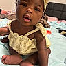 Caylee is registered to the contest to win money with this photo: baby, bed, blanket, child, crawling, curly_hair, cute, expression, face, foot, hand, headband, indoors, infant, person, portrait, skin, sleepwear, soft_fabric, yellow_clothing