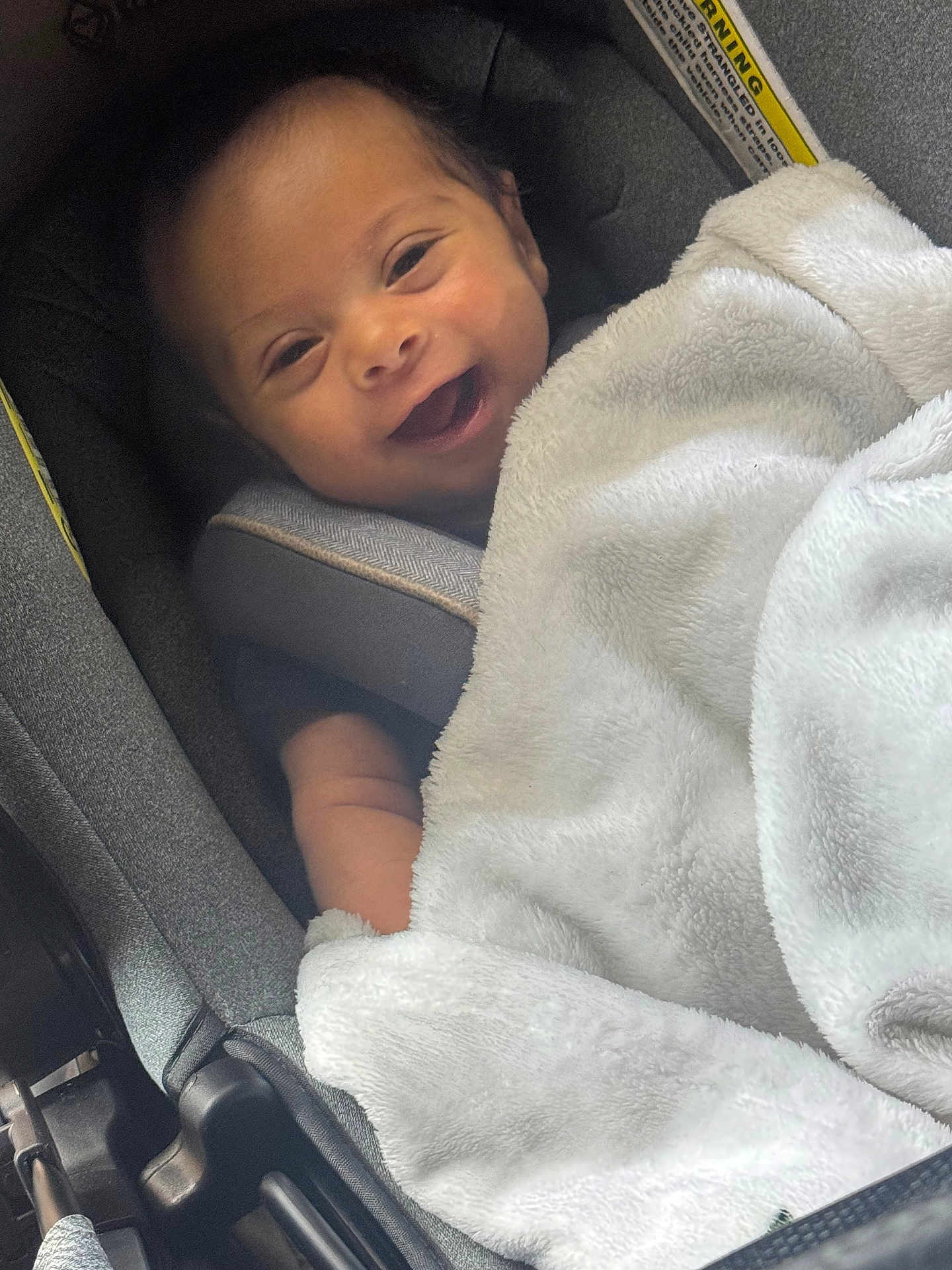 Quentin joined the competition — help win amazing prizes! baby, smiling, blanket, car_seat, infant, happy, child, soft, cozy, portrait, cute, seatbelt, indoors, toddler, clothing, face, person, comfort, young_child, closeup