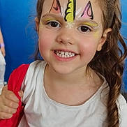 Eliana participe au concours pour gagner de l'argent avec cette photo : child, face_paint, smile, unicorn, young_girl, white_shirt, moon_graphic, red_jacket, curly_hair, portrait, indoor, happy, cute, person, closeup, bright_eyes, holding, hair, casual_clothing, background