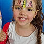 child, face_paint, smile, unicorn, young_girl, white_shirt, moon_graphic, red_jacket, curly_hair, portrait, indoor, happy, cute, person, closeup, bright_eyes, holding, hair, casual_clothing, background