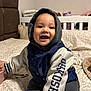 Haruto joined the competition — help win amazing prizes! baby, child, smiling, hood, jacket, bed, blanket, sippy_cup, indoor, cozy, happy, person, clothing, footwear, socks, furniture, home, infant, cute, portrait