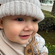Haruto is registered to the contest to win money with this photo: child, toddler, smile, hat, knit_hat, jacket, button, face, outdoor, greenery, trees, house, street, closeup, warm_clothing, cute, baby, portrait, happy, person
