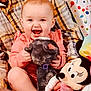Alena is registered to the contest to win money with this photo: baby, cheerful, child, cuddly_toy, cute, face, happy, holding, indoor, infant, lap, minnie_mouse, person, pink_clothing, plaid_shirt, plush_toy, seated, smiling, stuffed_animal, toy