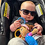 Alena is registered to the contest to win money with this photo: accessory, baby, car_seat, child, clothing, comfort, cute, headwear, indoor, infant, person, playtime, plush_toy, relaxed, seatbelt, security, small_person, soft_toy, sunglasses, toy
