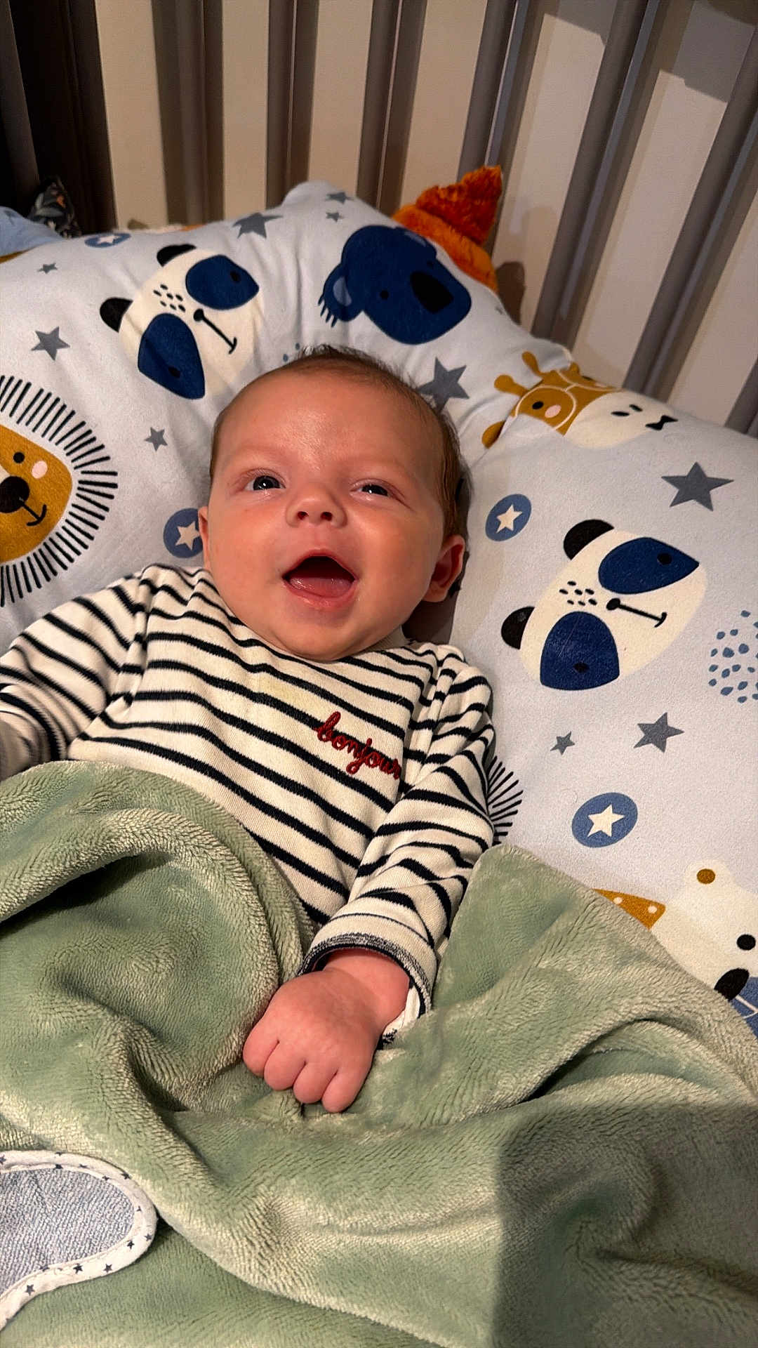 Augustin a rejoint le concours — aidez-le/la à gagner de superbes lots ! baby, infant, smiling, striped_shirt, blanket, pillow, animal_print, giraffe, bear, crib, cute, happy, indoors, child, portrait, hand, face, apparel, comfort, sleeping_area