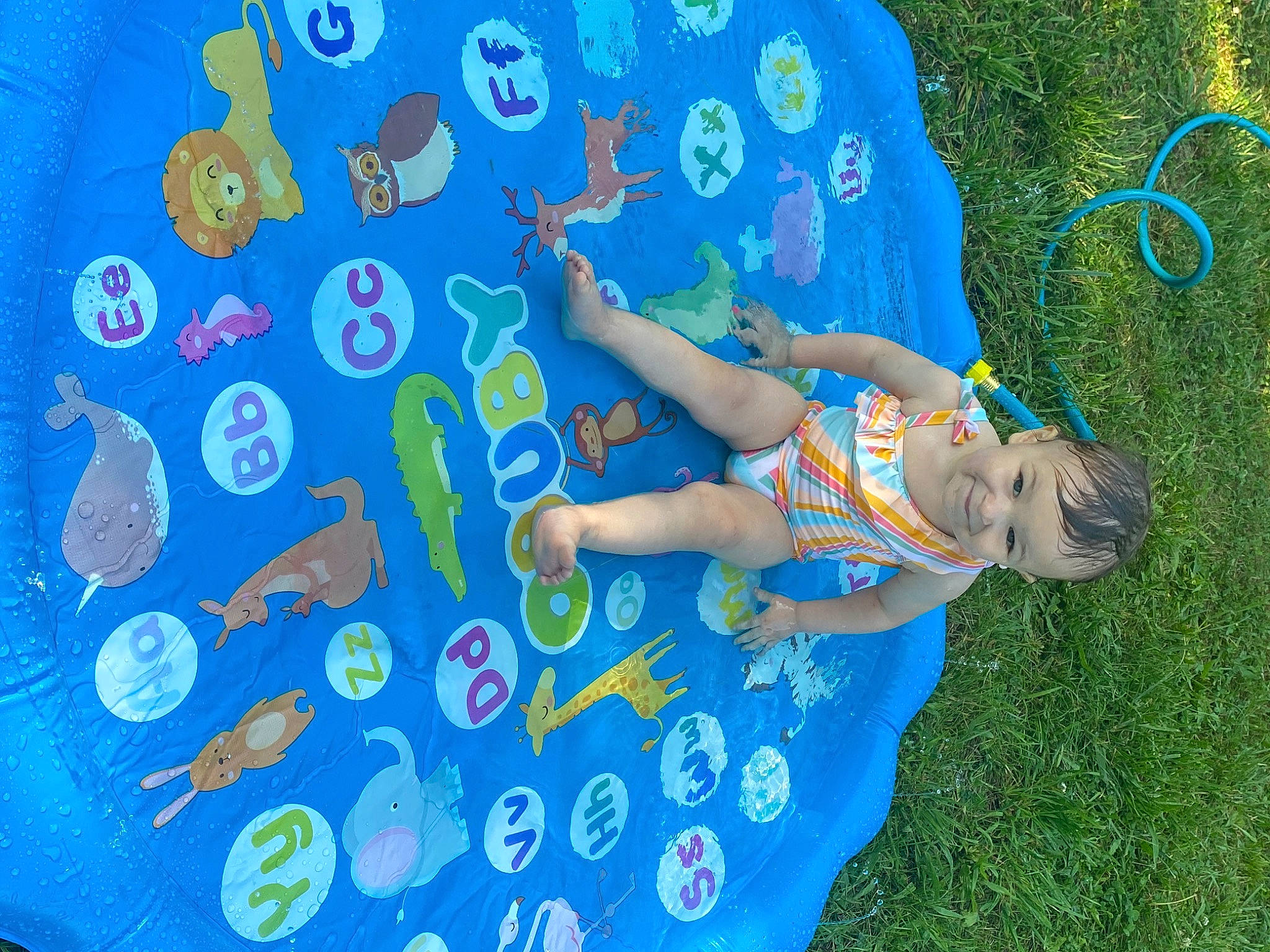 Hazlynn joined the competition — help win amazing prizes! aqua, azure, blue, electric_blue, fun, grass, happy, hat, human_leg, joy, leisure, organism, pattern, people_in_nature, person, recreation, shorts, summer, t_shirt, toddler