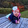 baby, infant, headband, flower, wooden_dock, river, water, grass, trees, nature, jacket, clothing, outdoor, smiling, happy, portrait, child, baby_girl, scenic, cute