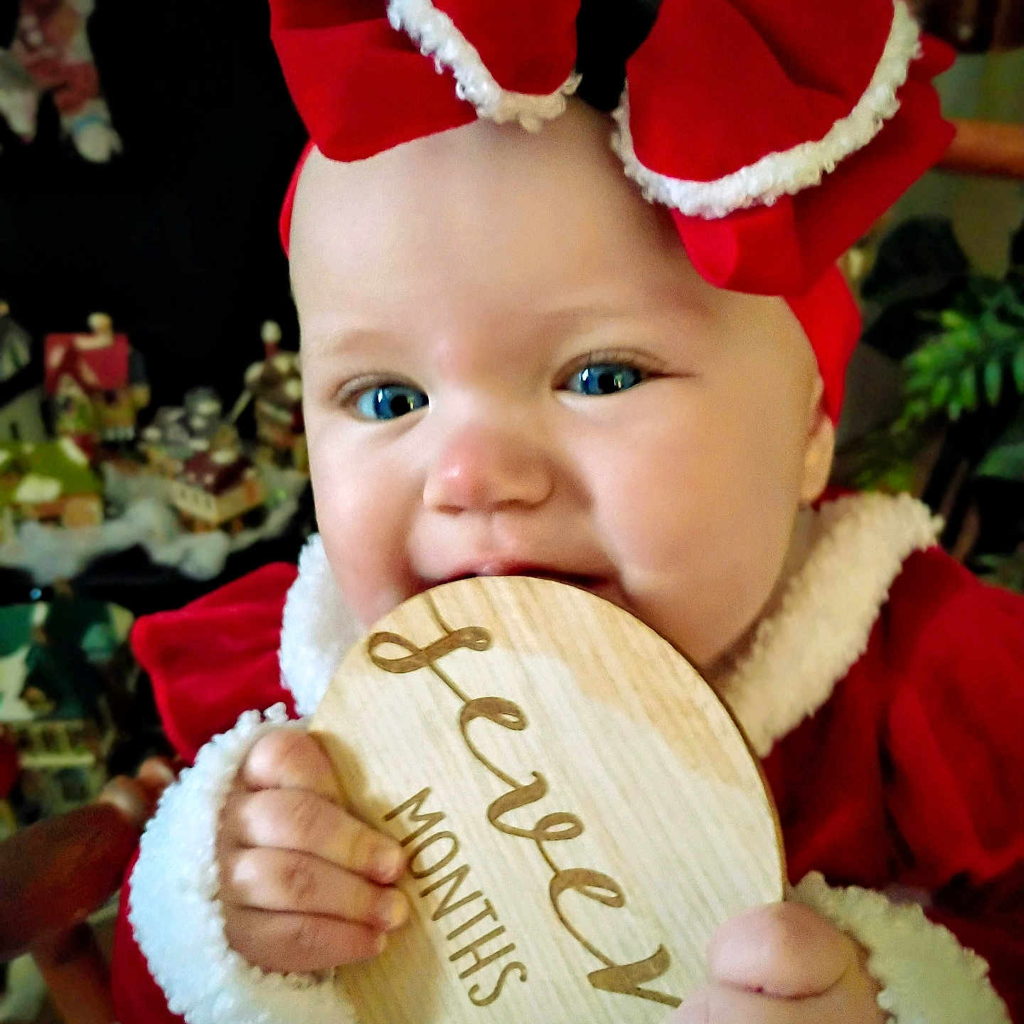 Covelea joined the competition — help win amazing prizes! baby, blue_eyes, candid, cheeks, child, cute, decorations, face, festive, hand, holiday, indoors, infant, portrait, red_bow, red_clothing, smiling, toy, twelve_months, wooden_plaque