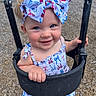 Daisy is registered to the contest to win money with this photo: toddler, child, swing, playground, headband, bow, blue_eyes, smile, happy, outdoor, summer_clothing, dress, plastic_swing, wood_chips, grass, daylight, person, cute, fun, play