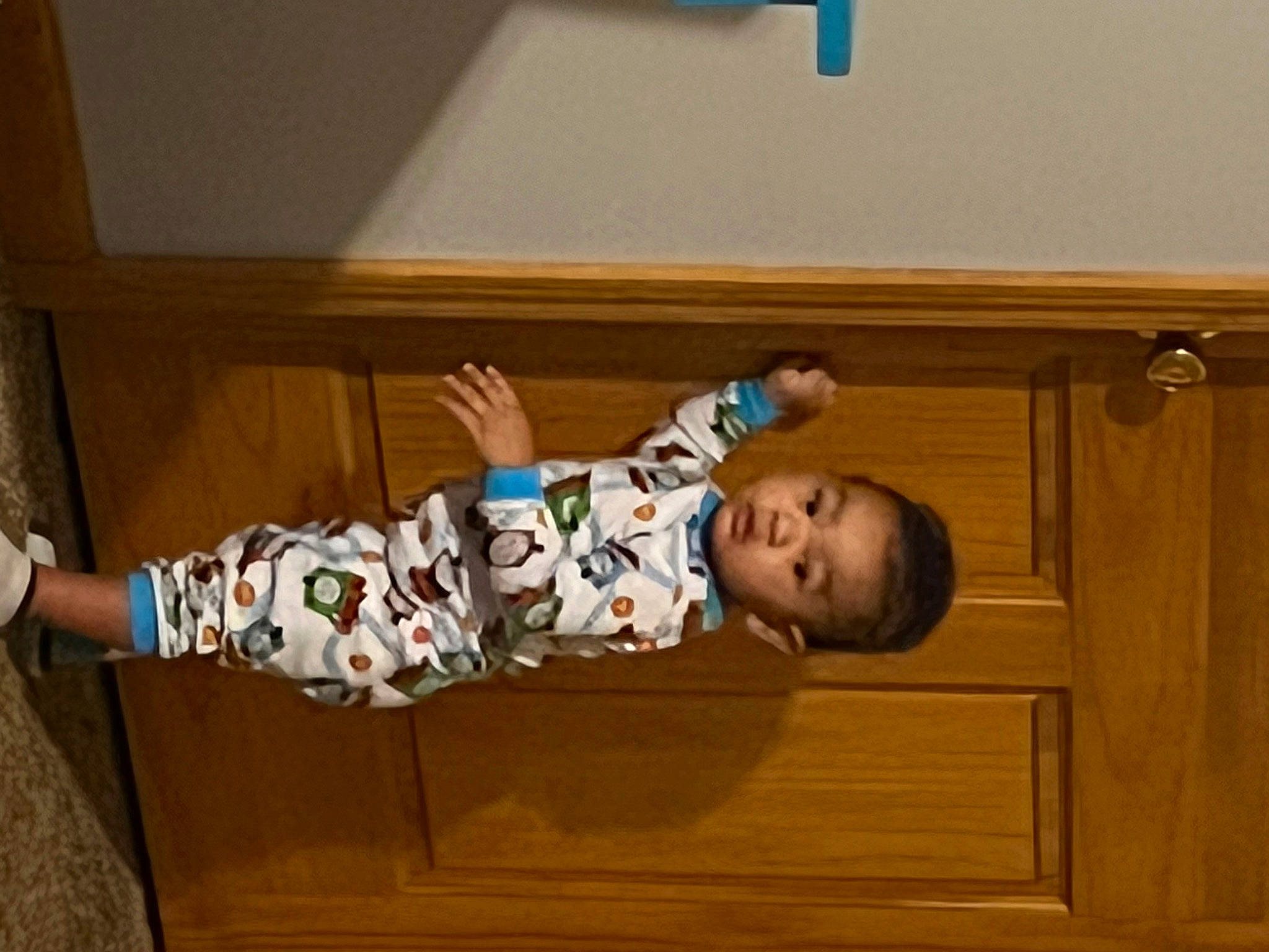 Makai is registered to the contest to win money with this photo: baby, baby_toddler_clothing, child, comfort, door, floor, flooring, foot, fun, hardwood, human_leg, person, room, sitting, sleeve, sock, toddler, varnish, wood, wood_stain