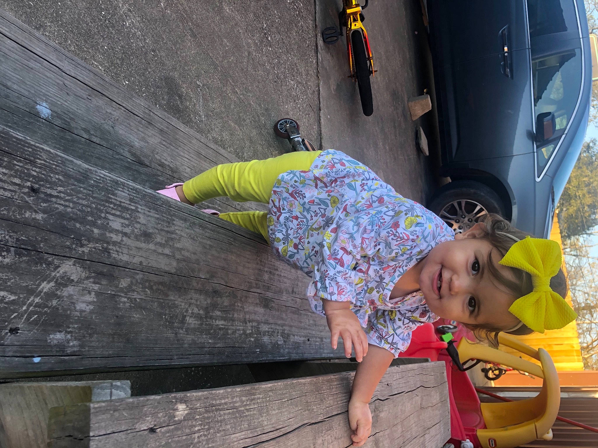 Juliette joined the competition — help win amazing prizes! auto_part, automotive_exterior, automotive_lighting, automotive_mirror, automotive_tire, automotive_wheel_system, baby_toddler_clothing, city_car, concrete, family_car, fender, flip_flops, foot, headwear, human_body, joy, person, plank, purple, sandal