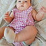 baby, child, infant, purple_checkered, onesie, blanket, soft_toy, sock, legs, arms, face, cute, indoor, lying_down, baby_clothes, smiling, skin, head, person, newborn