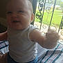 baby, child, indoor, window, iron_bars, striped_blanket, white_shirt, blue_shorts, fist, crawling, smiling, face, arm, leg, person, infant, home, daylight, blur, cute