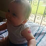 Leah joined the competition — help win amazing prizes! baby, infant, child, tattoo, arm, white_shirt, blue_shorts, striped_towel, door, metal_grill, window, indoors, curly_hair, chubby, smile, sitting, floor, skin, cute, natural_light