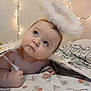Leah is registered to the contest to win money with this photo: angel, baby, bedroom, blanket, blue_eyes, child, costume, cute, expression, fairy_lights, feathers, hand, headband, indoors, infant, looking_up, portrait, skin, soft_lighting, young