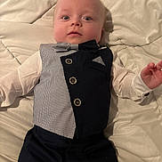 Richard joined the competition — help win amazing prizes! baby, infant, tuxedo, bow_tie, vest, clothing, white_shirt, lying_down, blanket, quilt, bed, cute, face, portrait, child, young, expression, hands, indoors, person