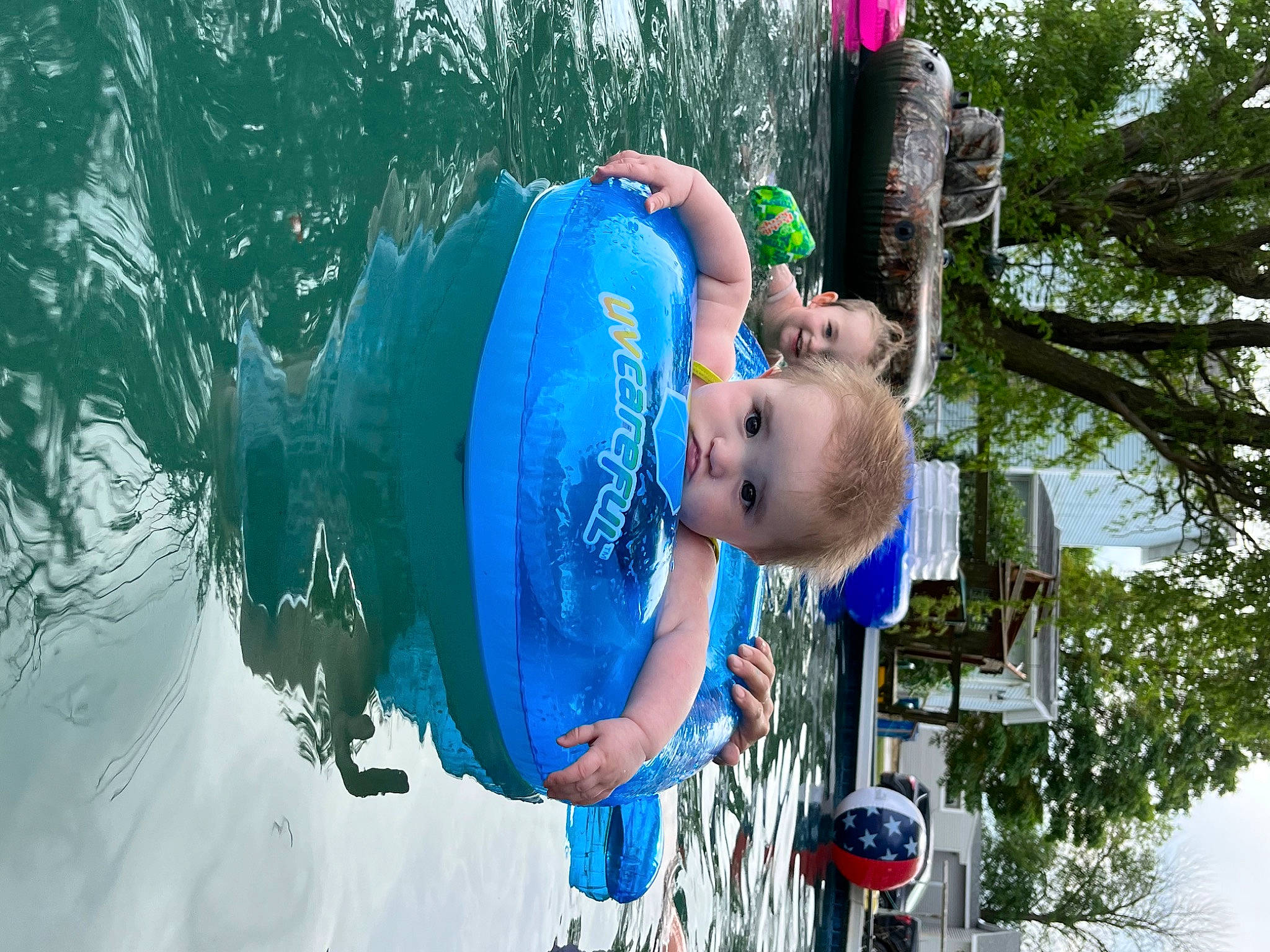 Amilia is registered to the contest to win money with this photo: azure, balloon, baseball_cap, cap, child, electric_blue, fun, happy, hat, headgear, joy, lake, leisure, person, personal_protective_equipment, recreation, sun_hat, toddler, tree, water