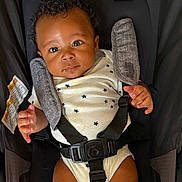 Raiden joined the competition — help win amazing prizes! baby, infant, car_seat, onesie, star_pattern, face, eyes, hands, straps, safety, child, cute, drool, clothing, seat, fabric, portrait, indoor, person, young