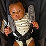 baby, infant, car_seat, onesie, star_pattern, face, eyes, hands, straps, safety, child, cute, drool, clothing, seat, fabric, portrait, indoor, person, young