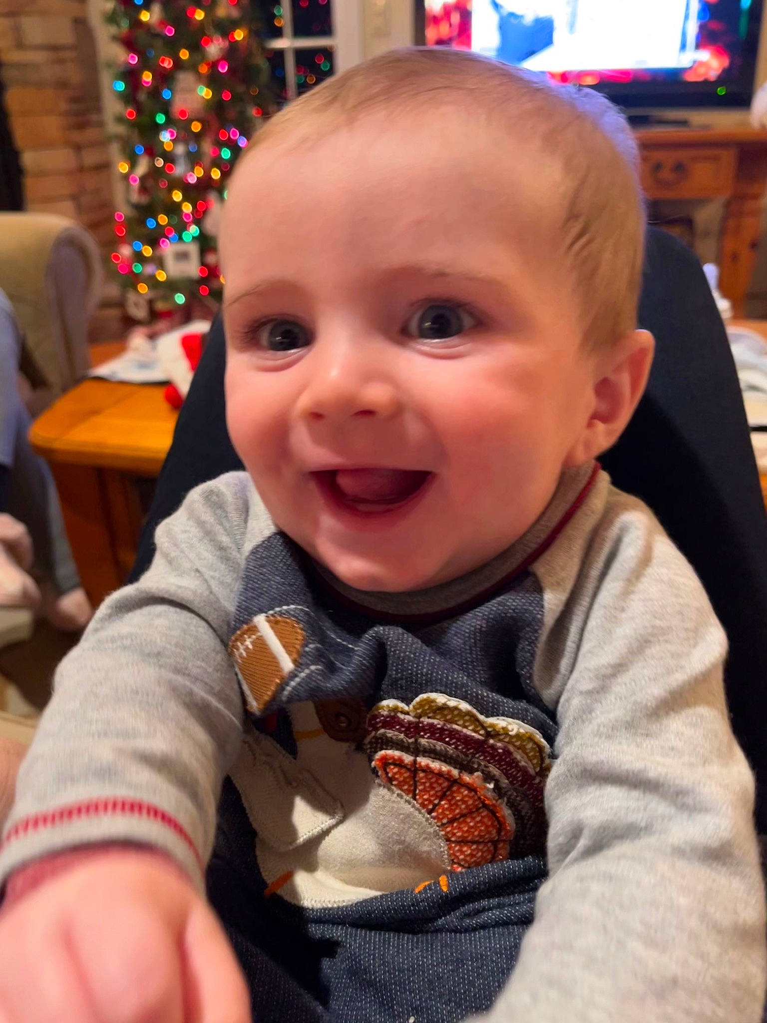 Maximilian joined the competition — help win amazing prizes! baby, baby_toddler_clothing, chair, cheek, child, christmas_tree, event, eye, fun, happy, holiday, iris, nose, person, sitting, skin, smile, t_shirt, television, toddler